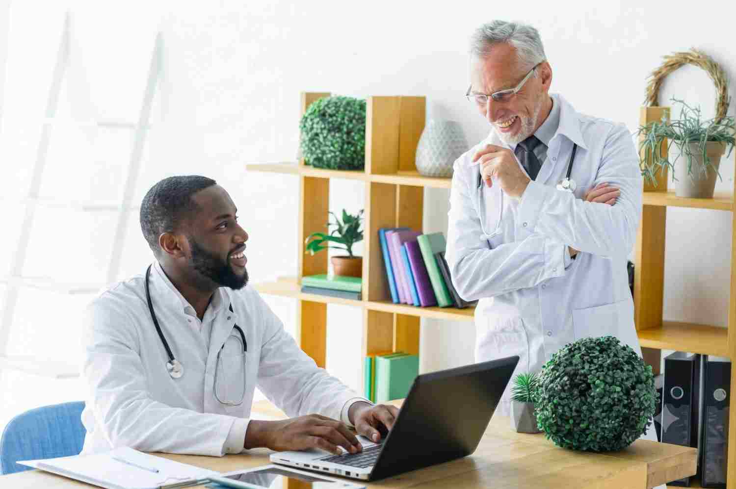 Doctor and medical assistant reviewing care with a consultant